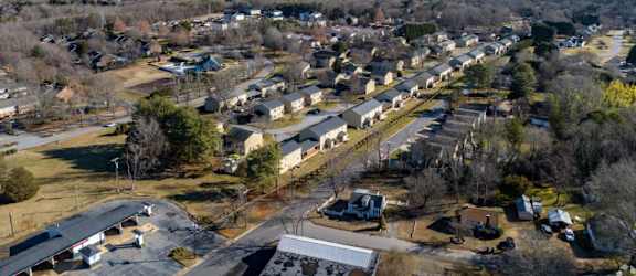 an aerial view of a neighborhood with houses and trees
