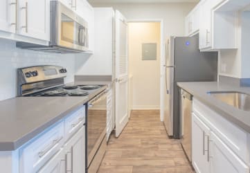 model kitchen with white cabinets and hardwood flooring
