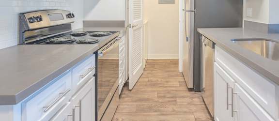 model kitchen with white cabinets and hardwood flooring