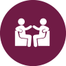 Two stick figures are sitting and shaking hands.