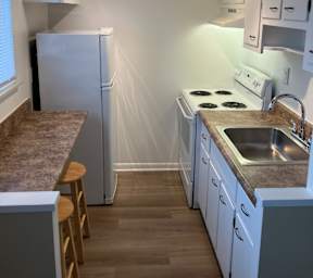 A kitchen with white appliances and cabinets at Emerald Village Apartments, Willoughby, 44094