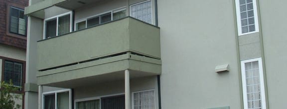 an apartment building with a car parked in front of it