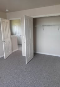 a bedroom with a closet and a door open