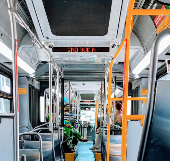 the inside of a city bus with empty seats
