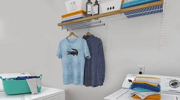 a laundry room with a washer and dryer and a shelf with clothes