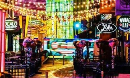 a city street filled with lots of neon signs