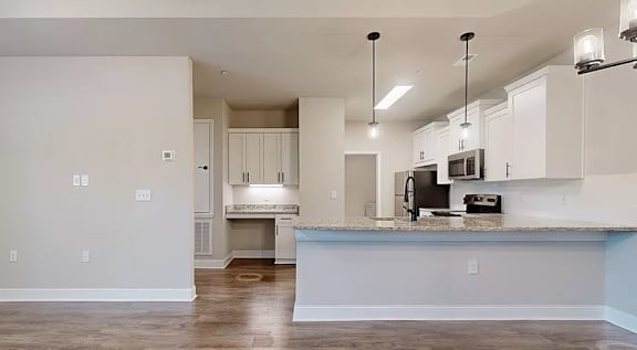 A kitchen with white cabinets and a countertop. at The Villas at Nature Walk, Huntsville, AL, 35824