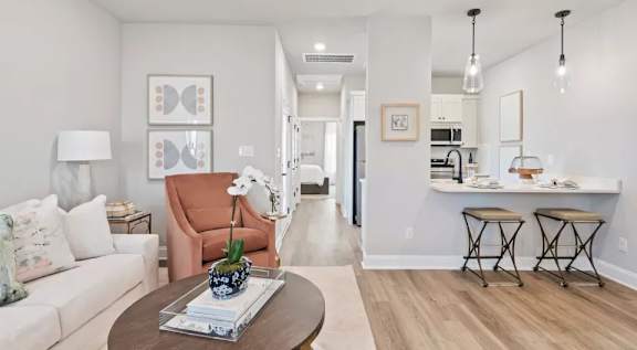 A modern kitchen with white cabinets and stainless steel appliances. at Ovation at Town Madison, Madison, 35758