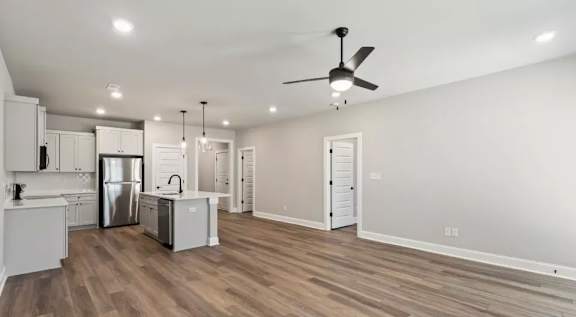 A spacious kitchen with a refrigerator, sink, and cabinets. at Ovation at Town Madison, Madison, 35758