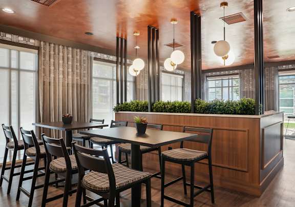 A modern dining room with a wooden table and chairs.