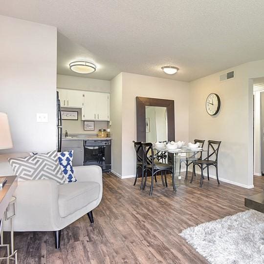 a living room with tall ceilings and a couch and a table