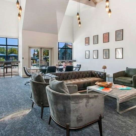 leasing office with couches chairs and a coffee table