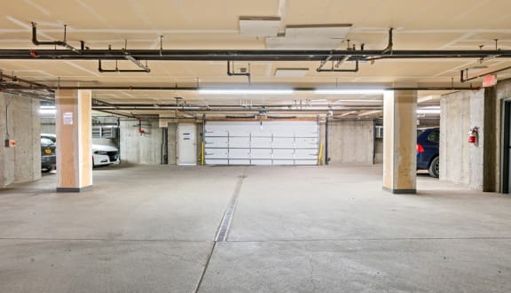 an empty parking garage with a white garage door  at ReNew Bayshore Townhomes, Anchorage