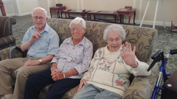a group of older people sitting on a couch