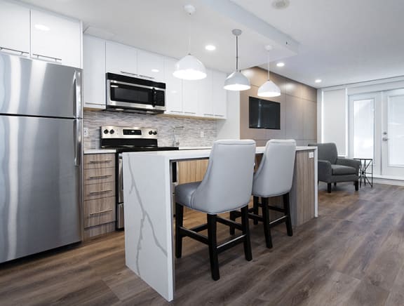 Wesley Place in Vancouver, BC Social room with full kitchen stainless steel appliances