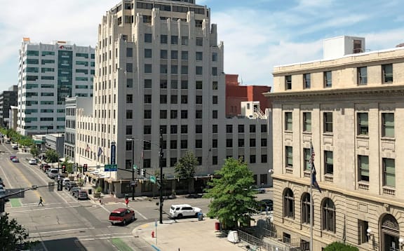A city street with cars and buildings.