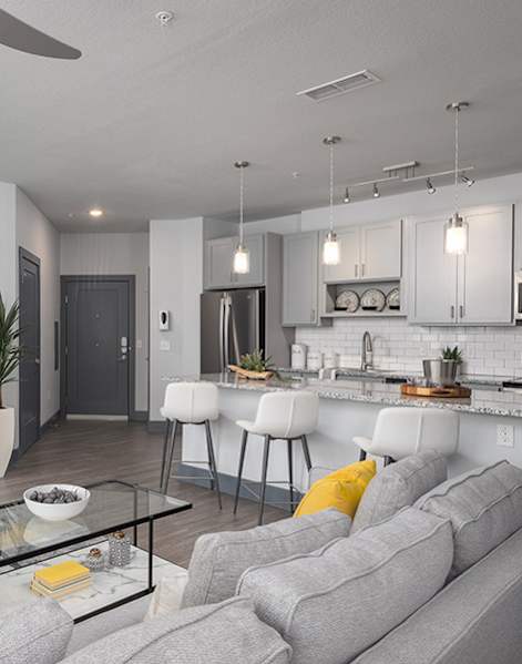 A modern living room with a yellow chair and a blue chair.