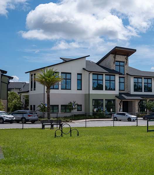 A modern building with a green lawn in front.
