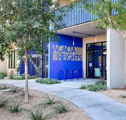 The front of a building with the name Acacia Heights on it.