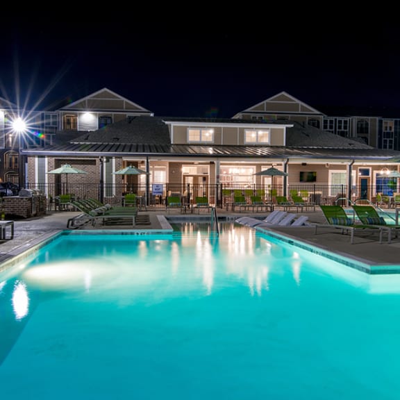 a swimming pool with a building in the background
