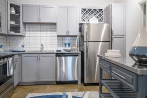 a kitchen with stainless steel appliances and white cabinets