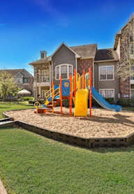 an empty playground in the middle of an apartment complex