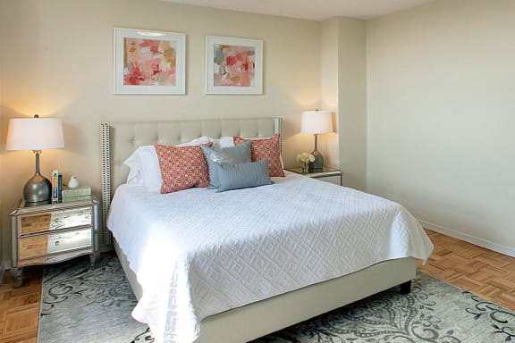 a bedroom with a bed and two lamps