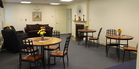 A dining room with a table set for six.