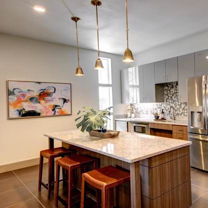 A kitchen with a bar area and a refrigerator.