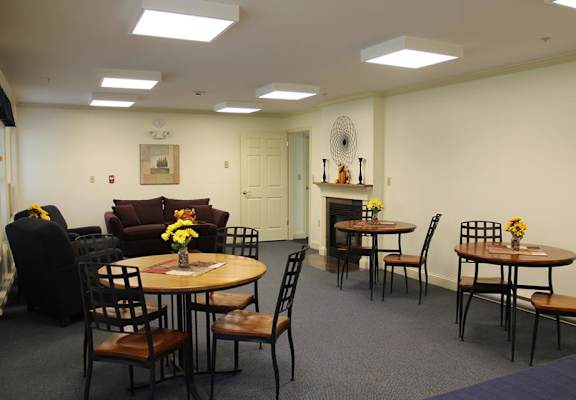 A dining room with a table set for six.