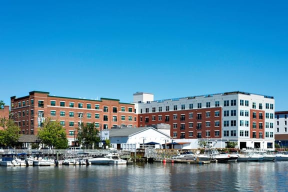 a group of buildings sitting next to a body of water