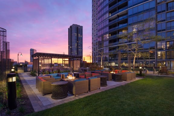 Outdoor fire pits, seating area, and gazebo at sunset at Kingsbury Plaza, Chicago, 60654