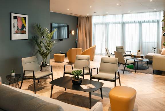 A living room with a variety of chairs and a coffee table.
