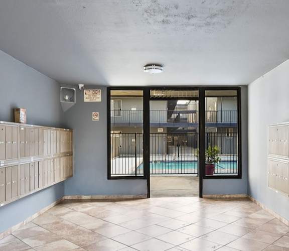 A room with a pool visible through the glass door.