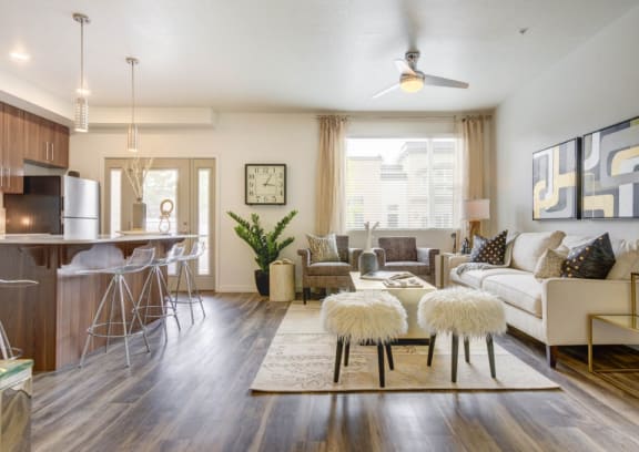 a living room with hardwood flooring and a ceiling fan