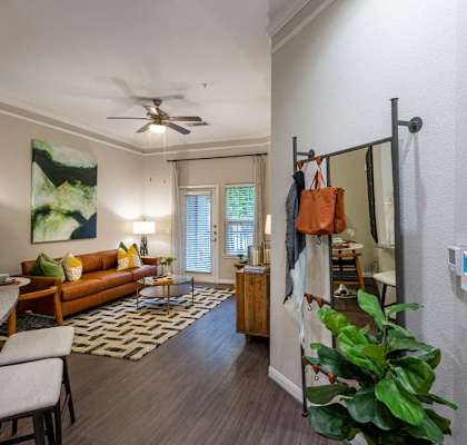 a living room with a couch and a ceiling fan
