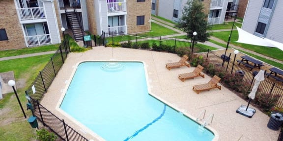 an aerial view of a swimming pool in front of an apartment building at Northchase, Texas, 78753