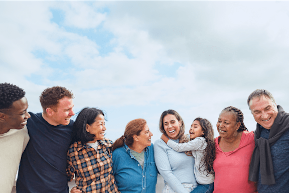 A group of people standing close together outdoors.