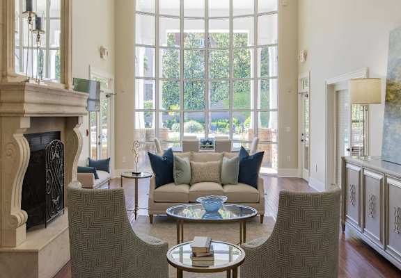 a living room filled with furniture and a large window
