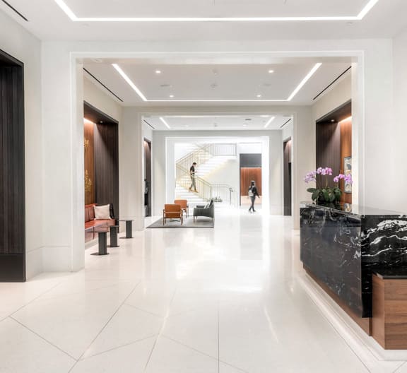 the lobby of the building is spacious and white