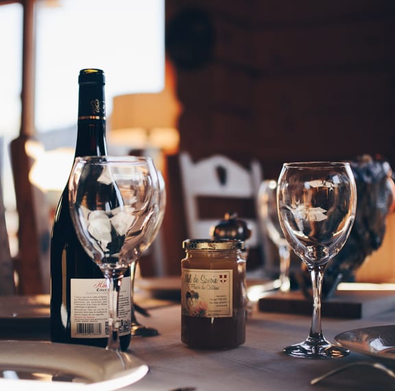 a table with two wine glasses and a bottle of wine