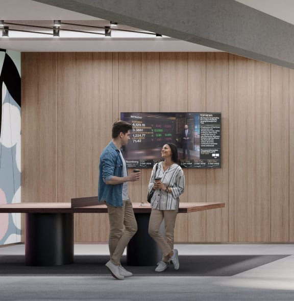 a man and a woman standing at a desk in a lobby
