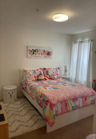a bedroom with a bed and a nightstand