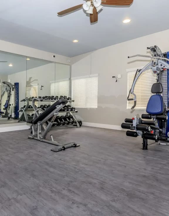 A spacious home gym with a variety of exercise equipment.