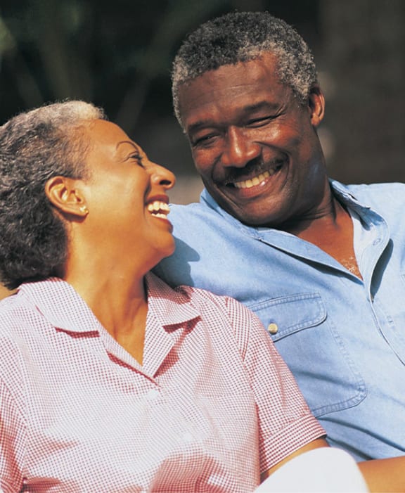 a man and a woman sitting on a swing
