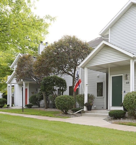 View of private, covered front entrance and sidewalk