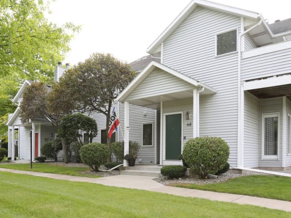 View of private, covered front entrance and sidewalk