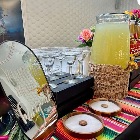 A table with a bottle of Tequila and glasses is set up.