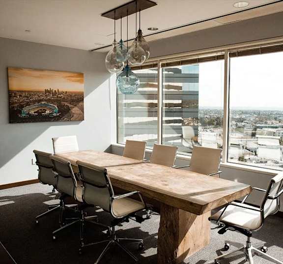 a conference room with a wooden table and chairs