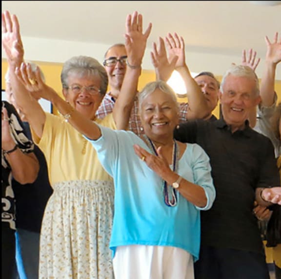a group of people with their hands in the air